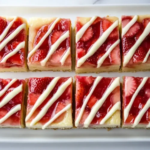 Strawberry cheesecake bar with compote and white chocolate drizzle