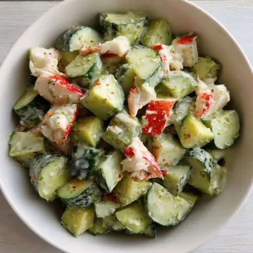 California roll cucumber salad in a bowl with crab, cucumber, and avocado.