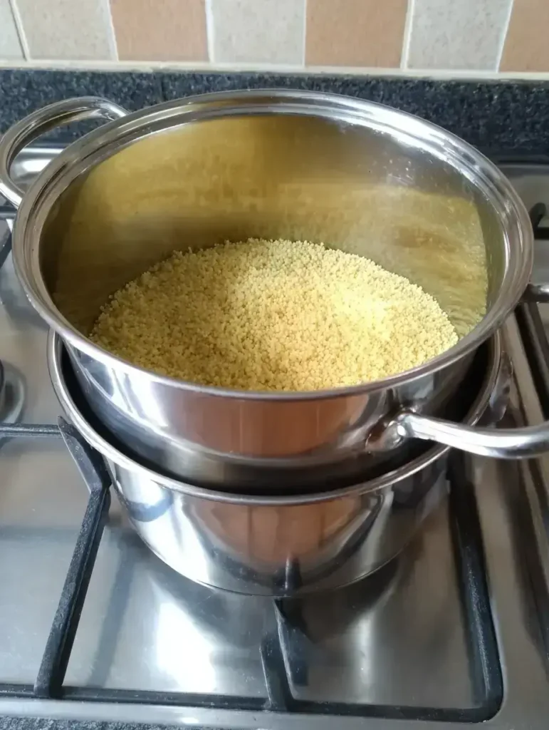 Cooking couscous in a pot for cowboy caviar couscous salad
